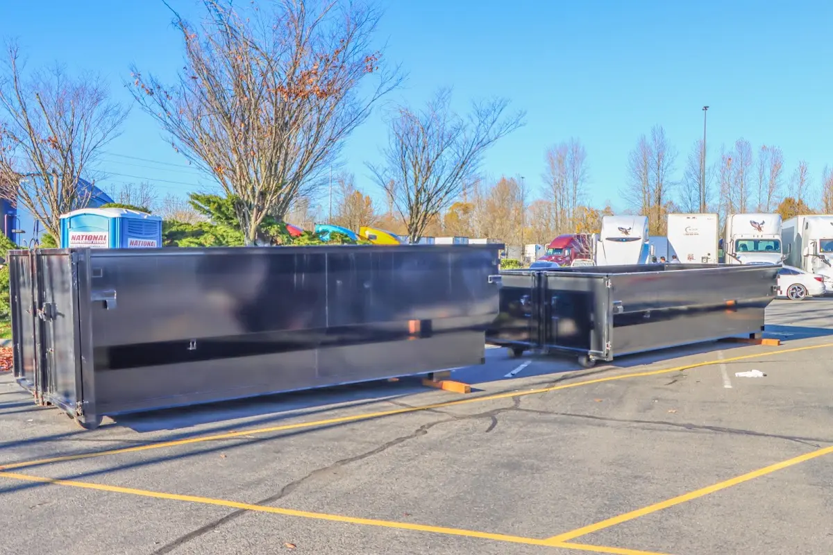 Professional dumpster rental service with roll-off container on residential driveway in Florence